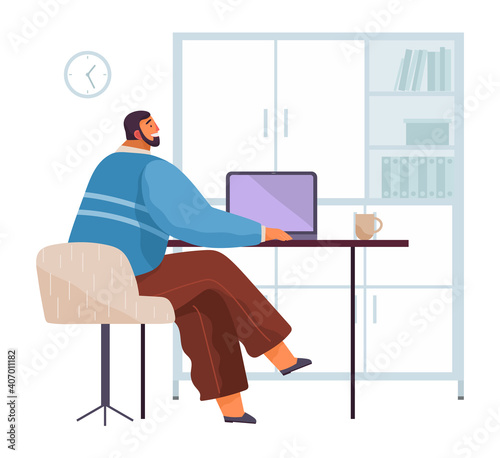 Businessman working at the computer sitting at a table in office space. Bearded man looking at the laptop screen back view. Freelancer doing work on the computer. Smiling manager at his workplace