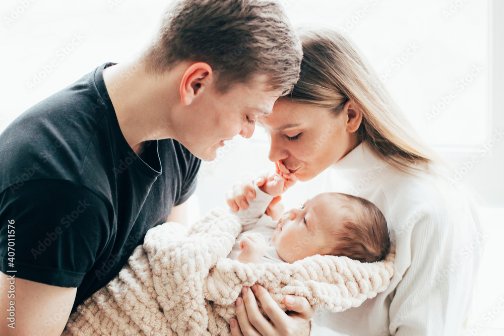 close-up of a man and a woman with a baby in their arms close-up of a man and a woman with a baby in their arms