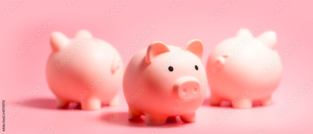 Piggy banks on isolated pink background with copy space. Panoramic Banner for Money Saving Concepts Piggy banks on isolated pink background with copy space. Panoramic Banner for Money Saving Concepts