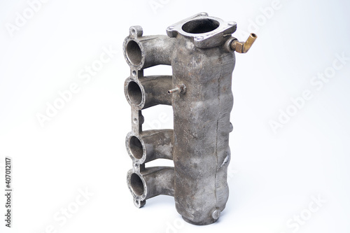 The intake manifold stands upright against a white background. Dirty air receiver and intake pipes. Second-hand supply chamber and runners.
