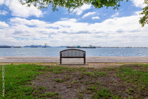 empty bench with sea space and boat background