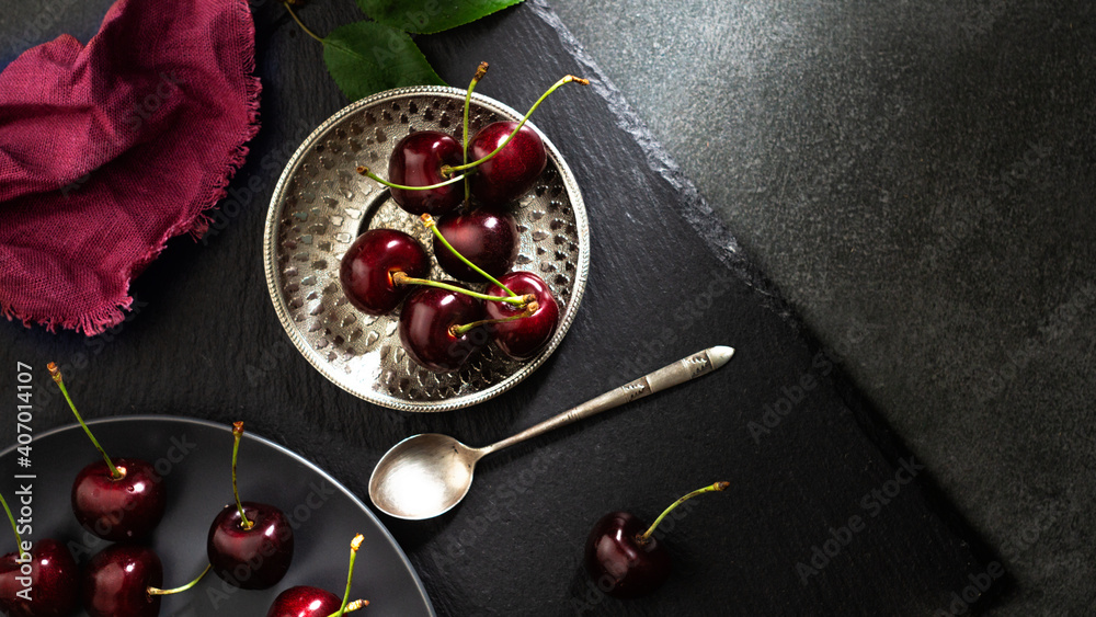 Ripe cherries in a metal plate. Top view