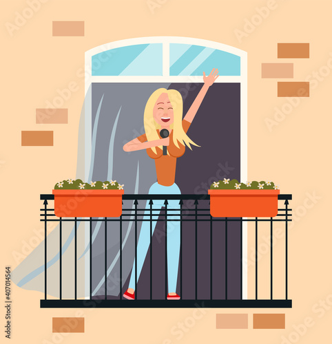 A girl with a microphone sings on the balcony of her house. Female character resting at home. Person stays at home, daily routine, hobby time relaxing. Woman performing music standing on the veranda