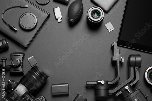 Camera and video production equipment on black background, flat lay. Space for text photo