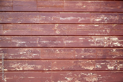 background texture of an old rustic wooden wall with peeling off paint