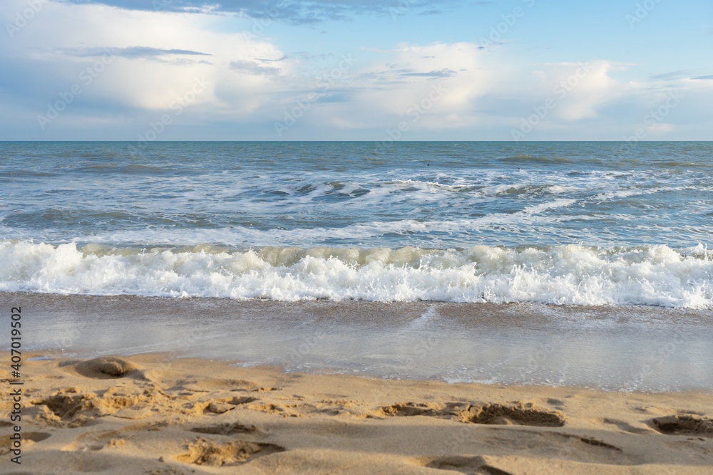 Coast with a wave rolling over it