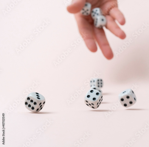 person s hand roll the dice cubes on the table  win gamble casino