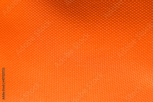 Texture of beautiful orange fabric as background, closeup view © New Africa