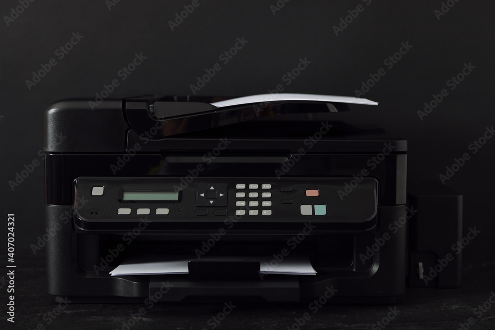 Modern printer with paper on black background Modern printer with paper on black background