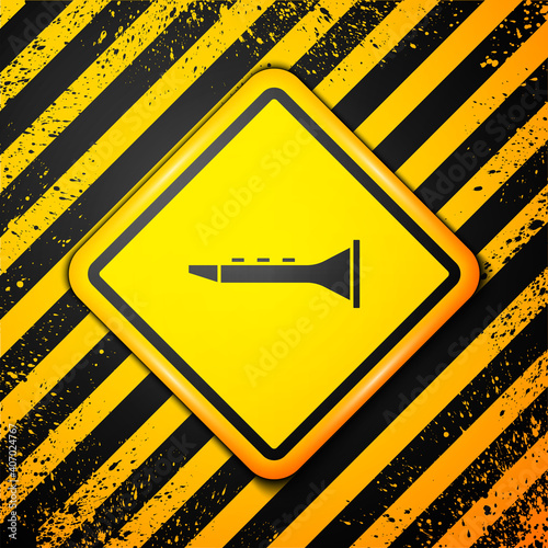 Black Clarinet icon isolated on yellow background. Musical instrument. Warning sign. Vector.