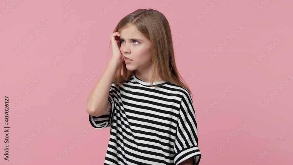 Puzzled pensive nervous little blonde kid girl 12-13 years old in white black striped t-shirt isolated on pastel pink background studio. Childhood lifestyle concept. Looking aside put hand on head Puzzled pensive nervous little blonde kid girl 12-13 years old in white black striped t-shirt isolated on pastel pink background studio. Childhood lifestyle concept. Looking aside put hand on head