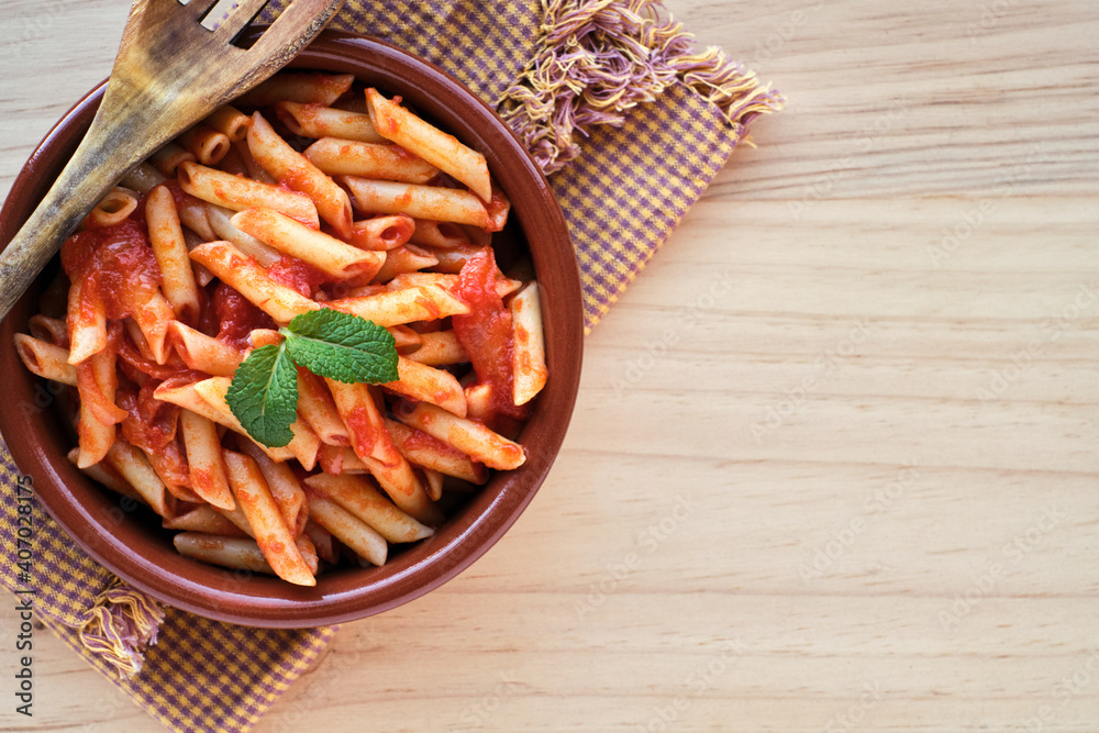 Macaroni and tomato in an earthenware casserole Macaroni and tomato in an earthenware casserole