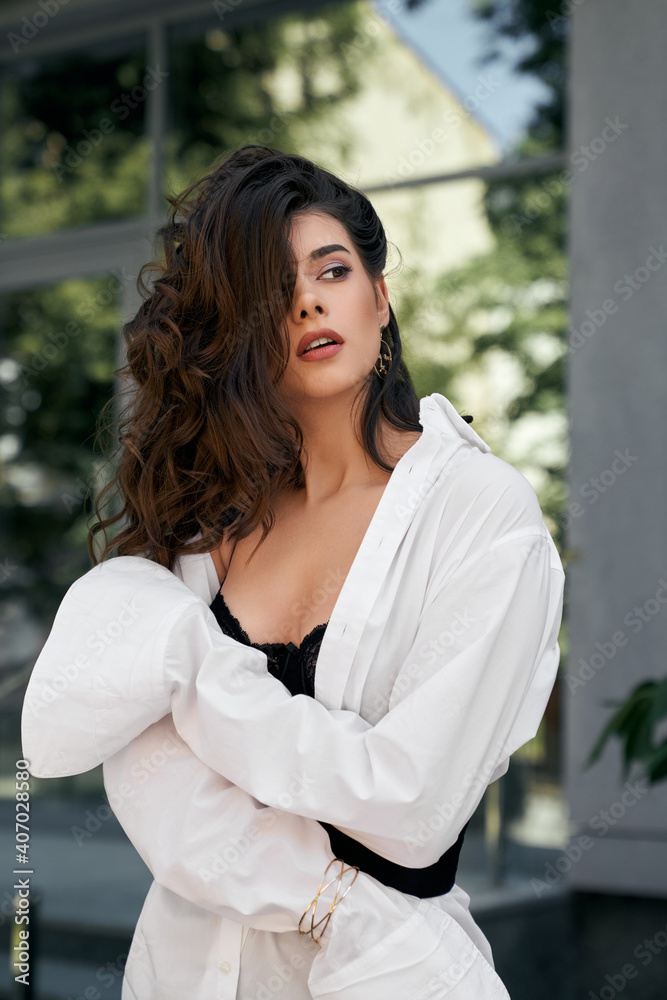 Fototapeta premium Fashionable model posing near business building.