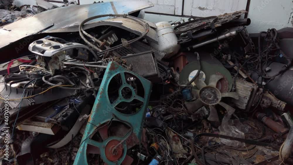 Tilt up shot of garbage waste metal plastic material from cars and machines Tilt up shot of garbage waste metal plastic material from cars and machines