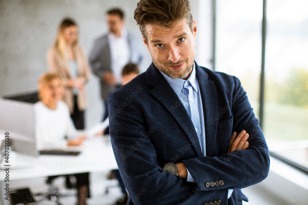 Handsome young business man standing confident in the office Handsome young business man standing confident in the office