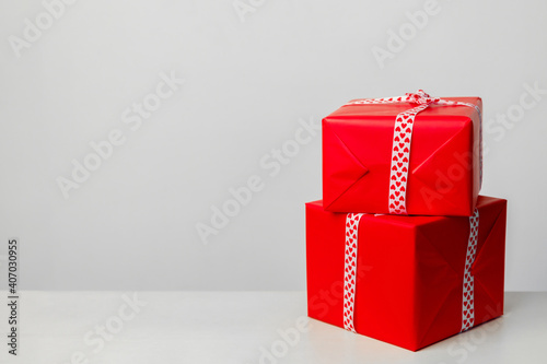 two gift boxes of red color, on a white background. Gift for valentines day, mothers day and christmas. Place for your text. Greeting card © Alexandra Selivanova