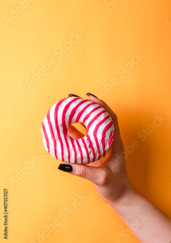 yellow background, donut in the hand, girl