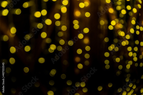 Abstract bokeh of yellow lights on black background. Christmas Lights