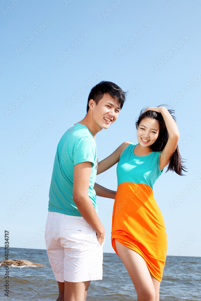 Portrait of young Couple standing on seaside Portrait of young Couple standing on seaside