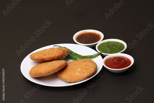 Indian snakes food kachouri or kachoudi kachori served with tamarind and mint chutney photo