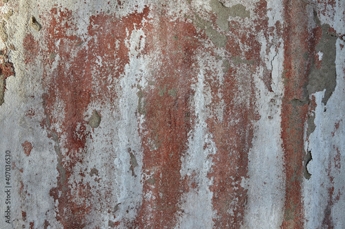 texture of old wall with scuffed plaster and peeling of white paint