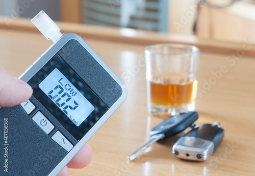 Alcoholic drink, breathalyzer and car keys - do not drink and drive concept photo