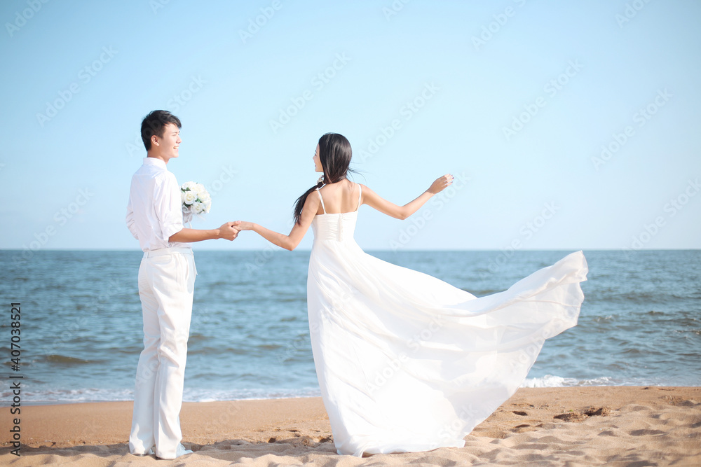 Young Couple in Wedding Dress on beach Young Couple in Wedding Dress on beach