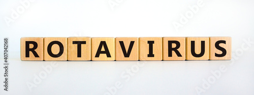 Rotavirus symbol. Wooden cubes with the word 'rotavirus'. Beautiful white table, white background. Medical, virus or rotavirus concept. Copy space.