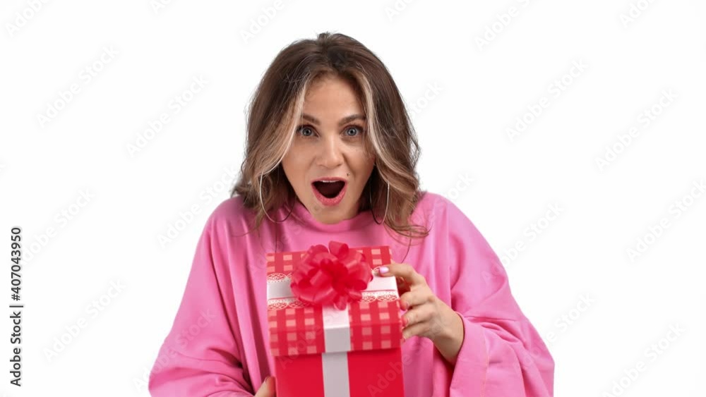 Portrait of amazement feminine open festive gift box isolated. Medium close up shot on 4k RED camera Portrait of amazement feminine open festive gift box isolated. Medium close up shot on 4k RED camera