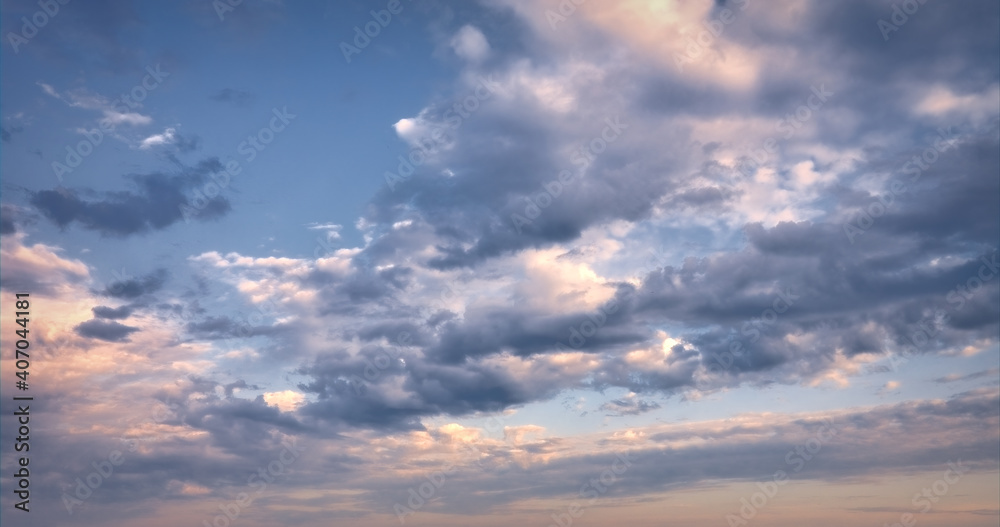 The sky at sunset. Cumulus clouds lit by the rays of the setting sun.