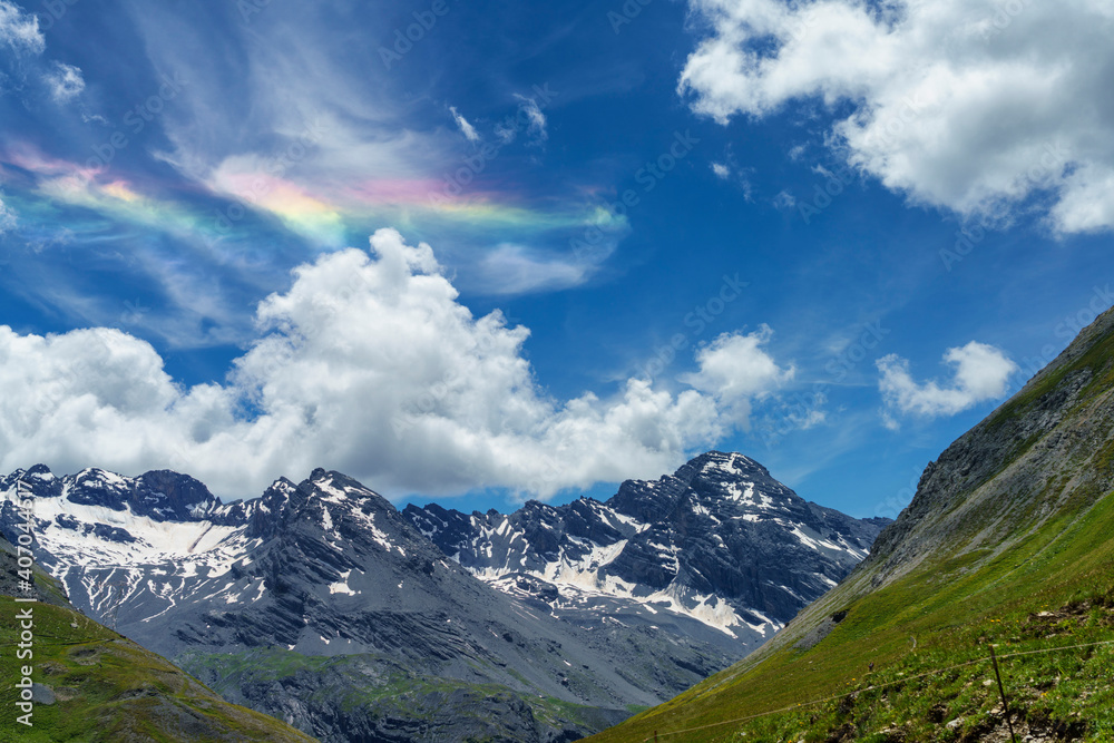 Iridescent cloud over the road to Stelvio pass (Lombardy) at summer