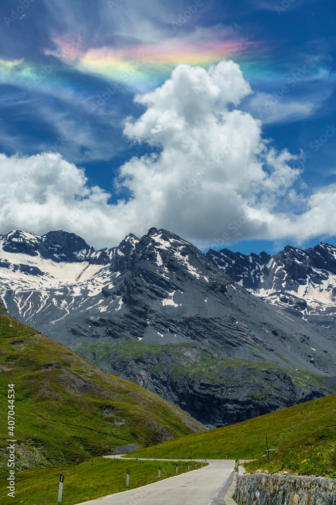 Fototapeta premium Iridescent cloud over the road to Stelvio pass (Lombardy) at summer