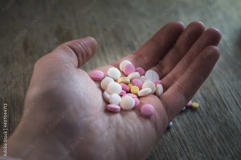 Colored pain reliever pills close up Colored pain reliever pills close up