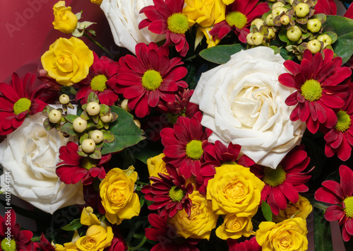 A beautiful bouquet of various flowers including roses. Floral background. Holiday postcard