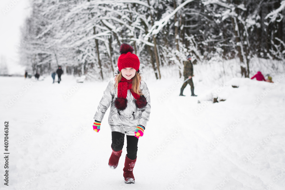 Little happy girl having fun in winter