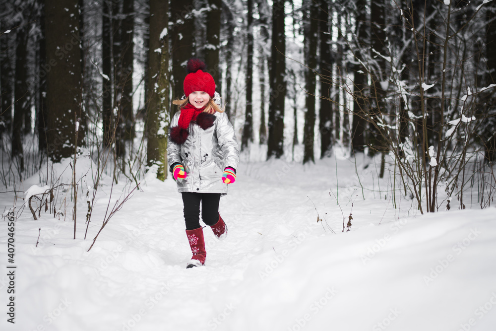 Little happy girl having fun in winter