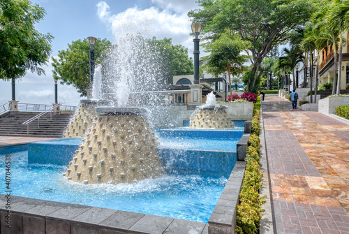 Water fountains in a public space near an area of the pier boardwalk in Guayaquil, Ecuador, on a sunny morning.