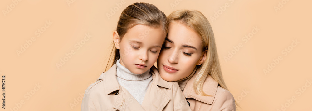 caring mother and daughter with closed eyes isolated on beige, banner