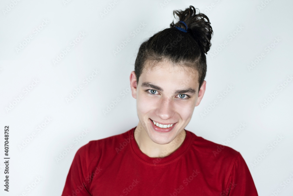 Cute, courageous teenager smiling on a light background, the guy has a beautiful smile and healthy white teeth. Portrait of a happy boy Cute, courageous teenager smiling on a light background, the guy has a beautiful smile and healthy white teeth. Portrait of a happy boy
