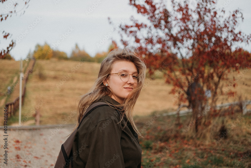 Young beautiful woman having a walk outdoors on golden our autumn. Lifestyle concept Young beautiful woman having a walk outdoors on golden our autumn. Lifestyle concept