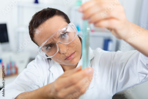 woman scientist take test tube in the laboratory