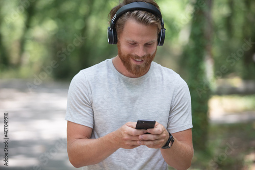 a young man in nature with headphones