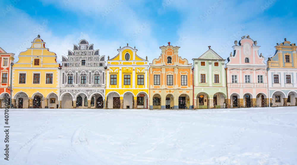 Main square of Telc with its famous 16th-century colorful houses, a UNESCO World Heritage Site since 1992, on a winter day with falling snow.