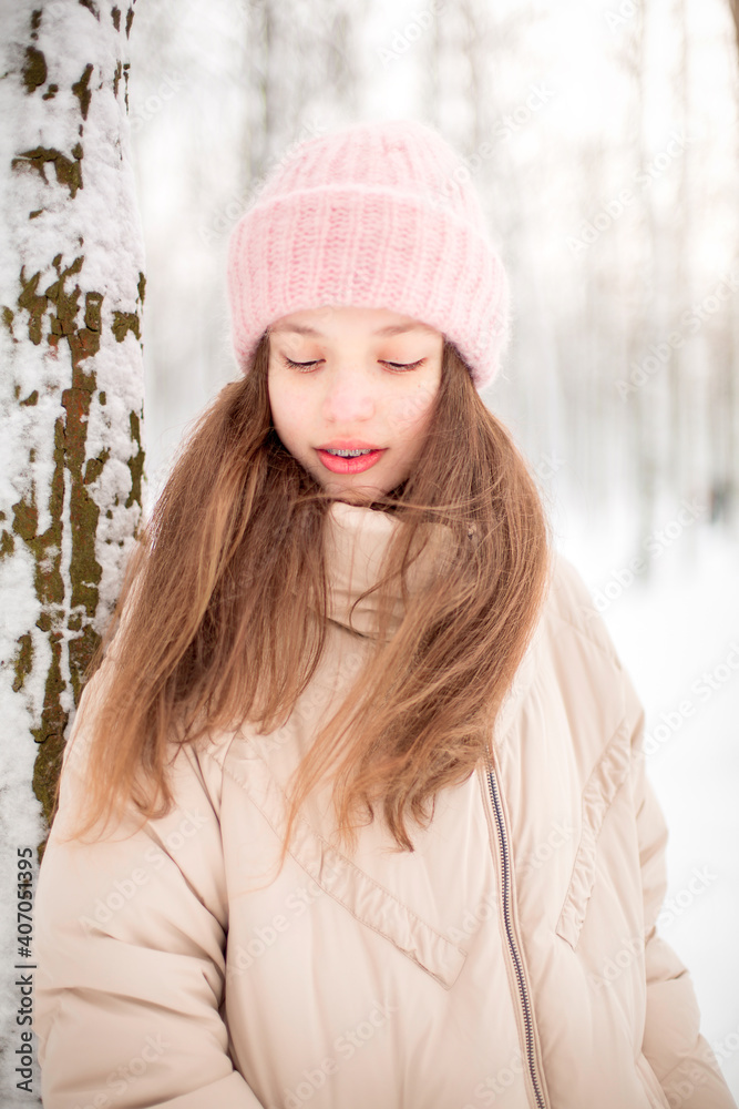 A winter portrait of a girl smiling. Image with selective focus and toning A winter portrait of a girl smiling. Image with selective focus and toning