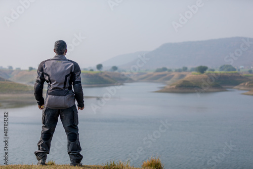 biker standing by lake water