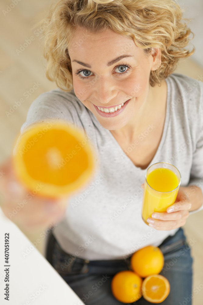 young woman showing oranges to camera young woman showing oranges to camera