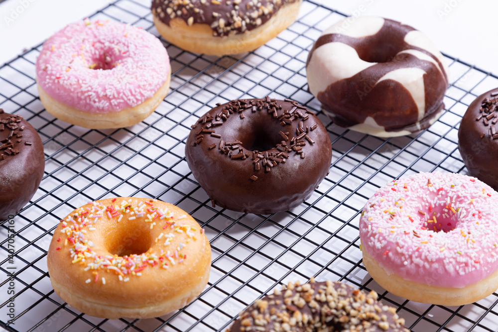 Mixed donuts on grid, on white background.