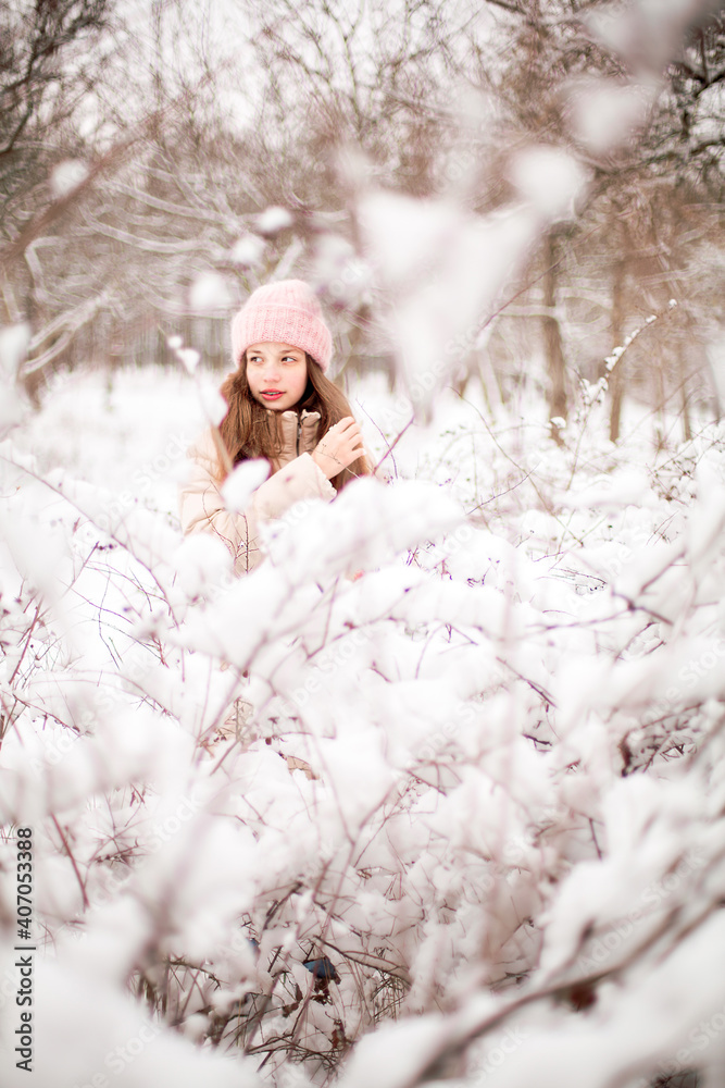beautiful girl stands by a snowy tree in winter
beautiful girl stands by a snowy tree in winter