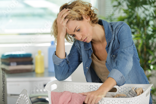 depressed woman doing the laundry