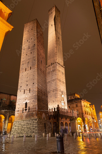 Bologna - The towers Torre della Garisenda and Torre della Asinelli and square Piazza della Mercanzia at night